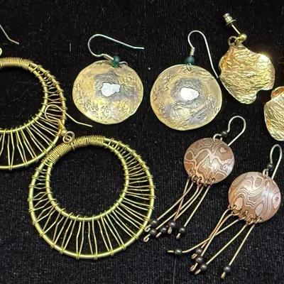 A grouping of earrings in earth tones