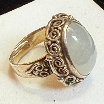 Oval cabochon mounted silver ring with filigree