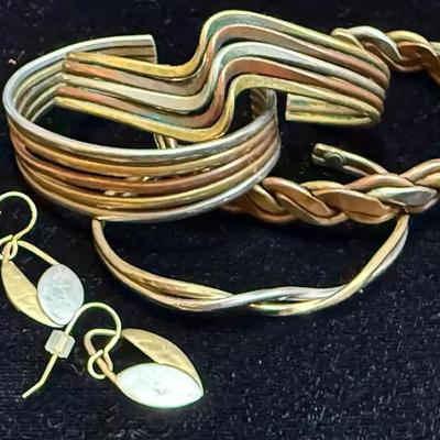 Mixed metal cuff bracelets a pair of earrings