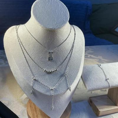 Three Shimmering Necklaces And One Bracelet
