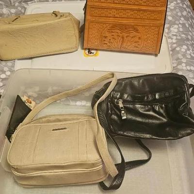 Picture frames and purses in totes with lids.
