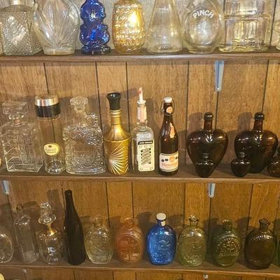 Many Different Clear & Colored Whiskey Decanters 