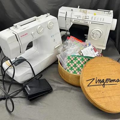 Two SINGER Sewing Machines with Assorted Sewing Supplies