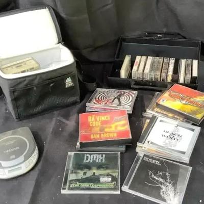 Compact discs, cassette tapes, Compact Disc player, tape storage items.