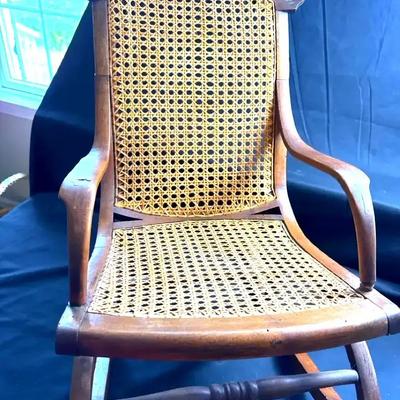 Lot 112:  Child’s Antique Wooden Rocking Chair with Cane Seat & Back