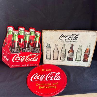 Three Coke Signs