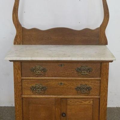 Sale Photo Thumbnail #166: 1166	OAK 2 DOOR, 2 DRAWER MARBLE TOP WASH STAND WITH HARP & TOWEL BAR, APPROXIMATELY 33 IN X 18 IN X 52 IN H

