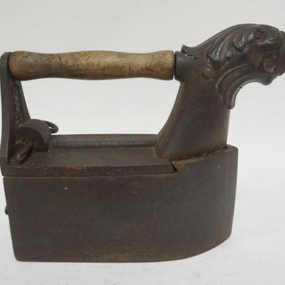Sale Photo Thumbnail #88: 1088	ANTIQUE COAL FLAT IRON W/EMBOSSED LIONS HEAD SPOUT, APPROXIMATELY 12 IN X 4 1/2 IN X 10 IN
