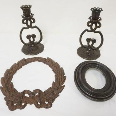 Sale Photo Thumbnail #54: 1054	GROUP OF ASSORTED CAST IRON ITEMS INCLUDING CANDLESTICKS, WREATH & OVAL FRAME, CANDLESTICKS MARKED FM CO, WREATH APPROXIMATELY 8 IN X 8 1/2 IN
