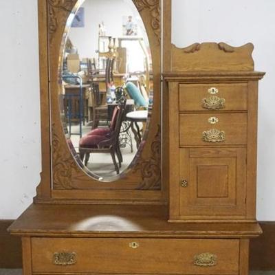 Sale Photo Thumbnail #191: 1191	OAK BONNET CHEST WITH LARGE OVAL MIRROR WITH CARVED EDGES, 4 DRAWER, 1 DOOR AND PANELED SIDES, APPROXIMATELY 49 IN X 22 IN X 81 IN H
