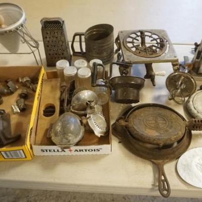 Sale Photo Thumbnail #238: 1239	GROUP OF ASSORTED KITCHEN AND RELATED ITEMS, INCLUDING GRISWOLD AND WAGNER WAFFLE MAKERS, STRAINERS, HOT PLATE, TOASTER, ETC.
