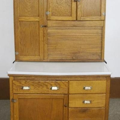 Sale Photo Thumbnail #185: 1185	WILSON OAK KITCHEN CABINET WITH BROWN SLAG GLASS PANELS AT TOP, APPROXIMATELY 42 IN X 25 IN X 67 IN H
