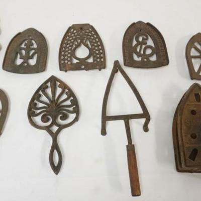 Sale Photo Thumbnail #100: 1100	GROUP OF ASSORTED ANTIQUE TRIVETS INCLUDING CAST IRON ENTERPRIZE, LARGEST APPROXIMATELY 12 IN X 5 IN X 2 IN
