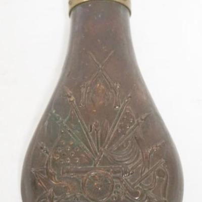 Sale Photo Thumbnail #60: 1060	ANTIQUE BRASS POWDER FLASK W/EMBOSSED CANON, GUNS, & FLAGS, APPROXIMATELY 8 IN HIGH
