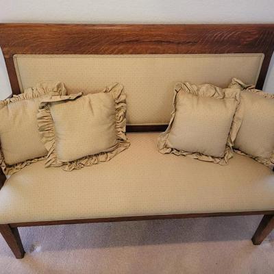 Antique Upholstered Wooden Settee – Carved Back with Neutral Fabric Seat & 4 Ruffled Accent Pillows