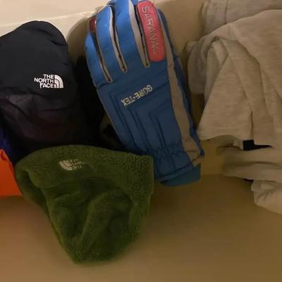 Variety Of Ski Gloves And Beanies With Miscellaneous Undergarments For Skiing