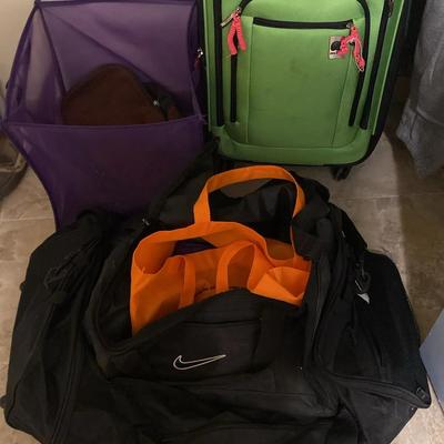Assortment Of Duffels And Totes With A Bright Green Suitcase
