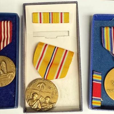 Three military medals and ribbons, likely from World War II: