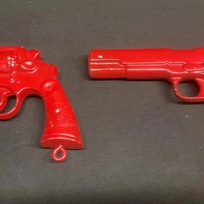 A pair of vintage solid red color replicas for non-firing, dummy training, pistols used for sasafety