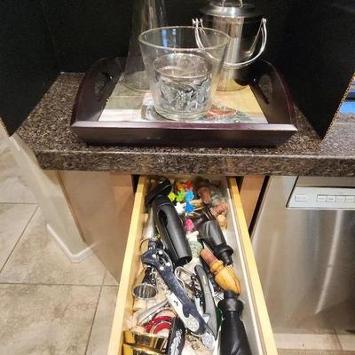 Counter Full of Wine Supplies with Serving Tray and Drawer of Stoppers and Other Tools