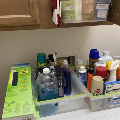 Assortment Of Cleaning Supplies, Laundry Supplies And Household Cleaning Items Such As Duster Cloths
