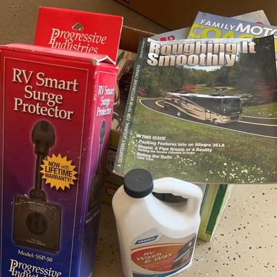RV Motorhome Smart Surge Protector With Box Of Touring Magazines And Auto Wash