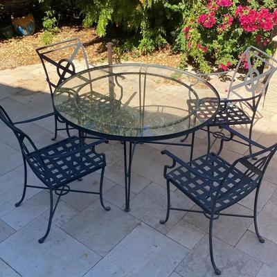 Wrought Iron Patio Furniture Four Chairs And Table And Umbrella Stand