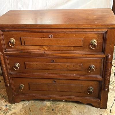 Three Door Dresser With Spool Decoration