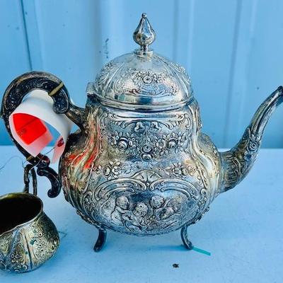 Continental Highly Repousse Teapot and Matching Creamer.