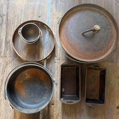 8614 • 2 cast iron pots 2 cast iron baking pans 1 cast iron dutch oven