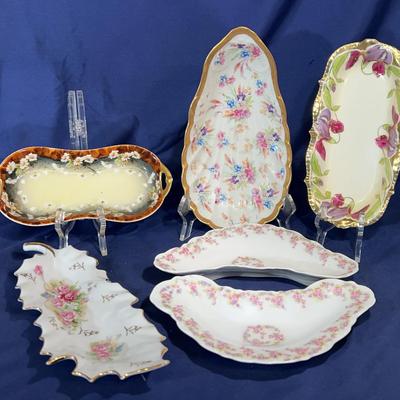 Collection of antique porcelain trays with floral designs 