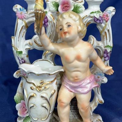 Antique Camille Naudot porcelain figurine featuring a cherub, vase, and double candle holder