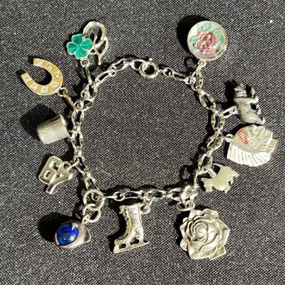 Vintage charm bracelet with a variety of Silver tone and Gold charms 