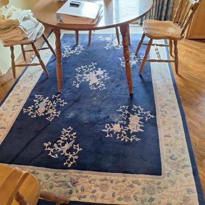 Vintage wood dining table.  Woven rug.