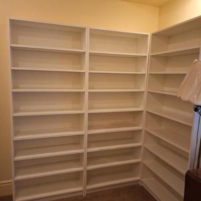 Large white bookshelves.  Sold separately.