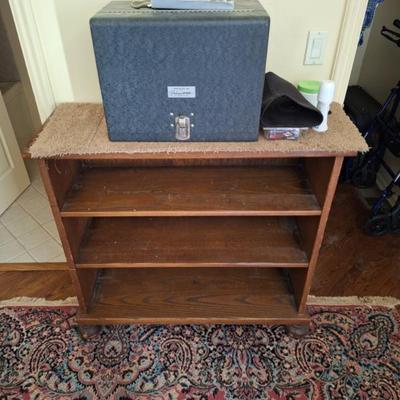 Vintage Pachmayr gun case.  Small bookshelf.