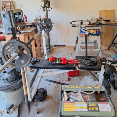 Work bench w/free weights.  Wood working equipment.