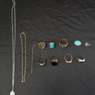 Lot 423: Vintage Men’s Costume Jewelry Lot – 10–15 Rings (Sizes 10–15) with Chains and Pendant