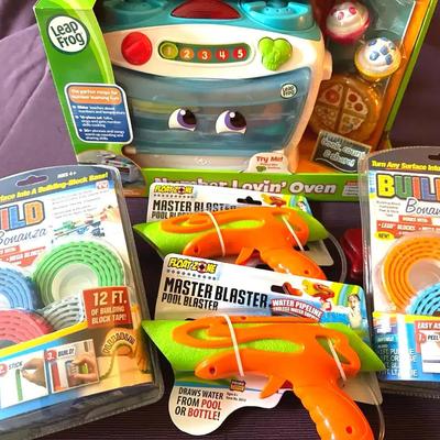 Lot 142:  Kids Toy Lot – LeapFrog Oven, Master Blaster Water Guns & Build Bonanza Block Tape