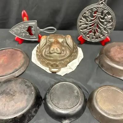 Lot 114:  Vintage Cast Iron Cookware & Kitchenware Lot – Skillets, Pig Mold, Sad Iron, and Trivets