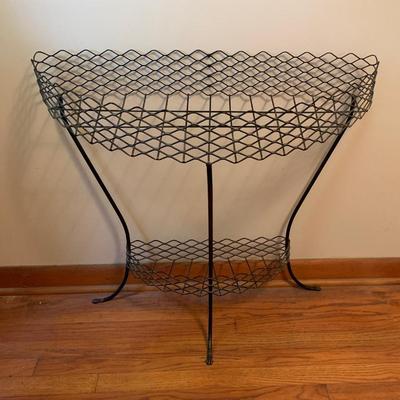 Mid-century metal mesh demi lune stand, 30” wide, 13” deep.