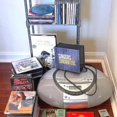 Sony CD Player, Magnavox Boombox, CD Collection, Thriller VHS Tape and Storage Shelf