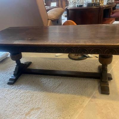 This vintage coffee table with intricate carvings dates back to the early 1960s and was originally purchased in England.Measures 22"...
