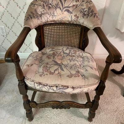 Vintage armchair with turned legs, cane backing and floral upholstery. $40