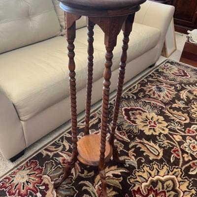 Vintage mahogany wooden barley twist 2-tier plant stand with detailed carvings. Measures 11" wide at top by 40" tall.