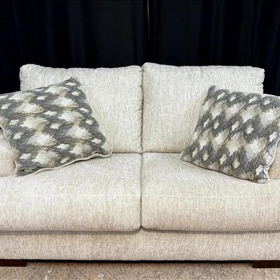 Ashley Furniture Beige Upholstered Loveseat with Accent Pillows