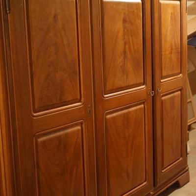 This is large cherry wardrobe cabinet with three sections  two doors lock.