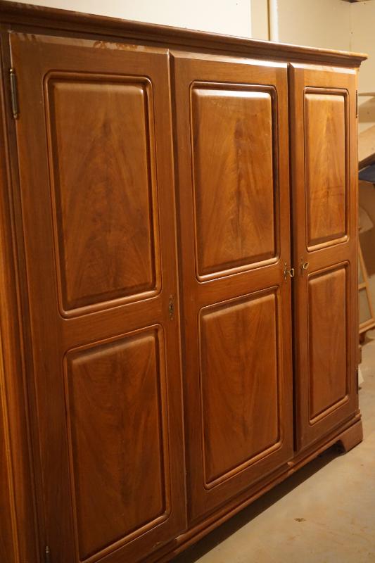 This is large cherry wardrobe cabinet with three sections  two doors lock.