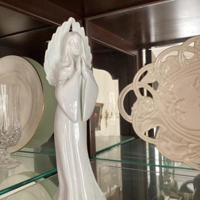 White cereamic statue of woman with flowing dress