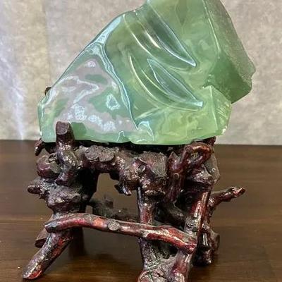 Green Stone On Wooden Display 
